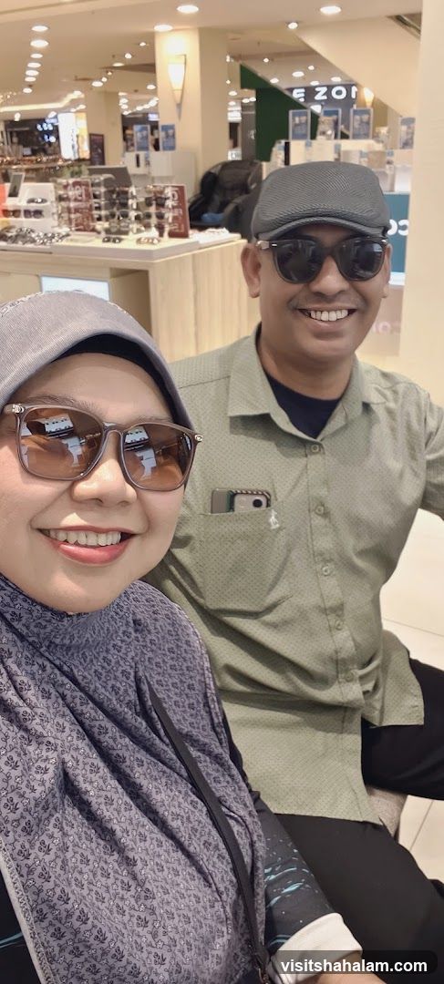 Couple trying on sunglasses