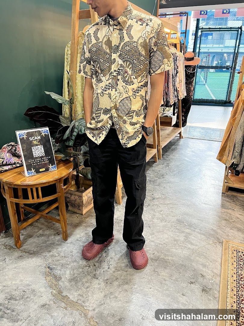 Man in patterned shirt and black pants