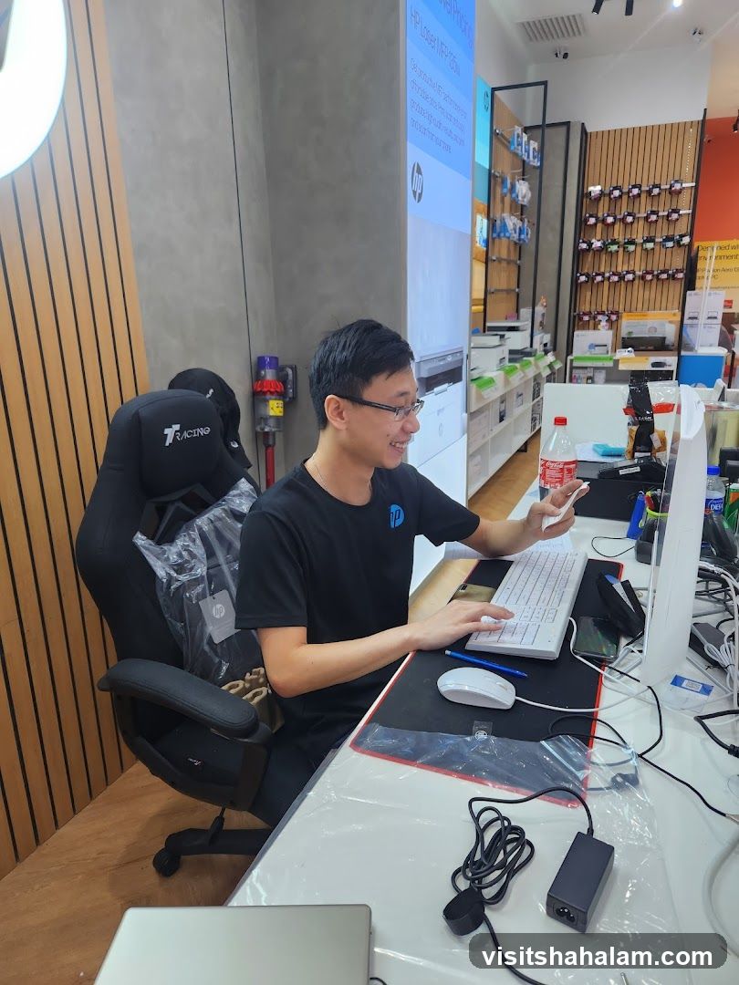 Man working at a computer in a store