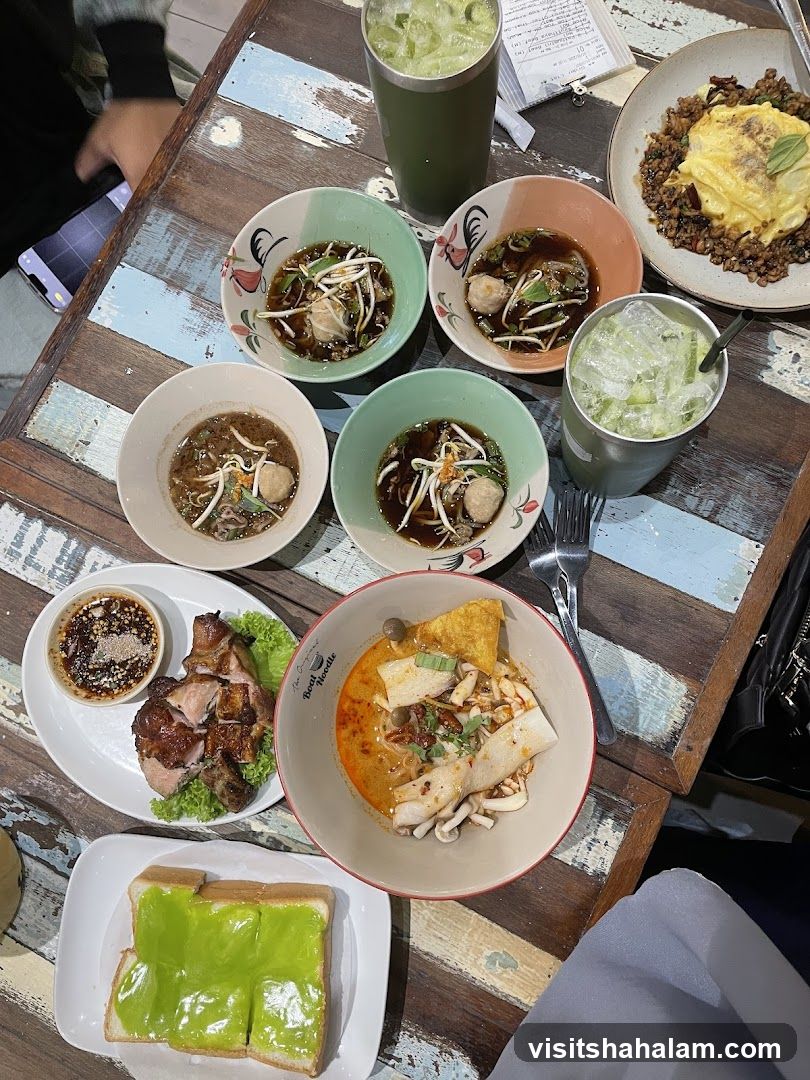 Table with various Thai dishes and drinks
