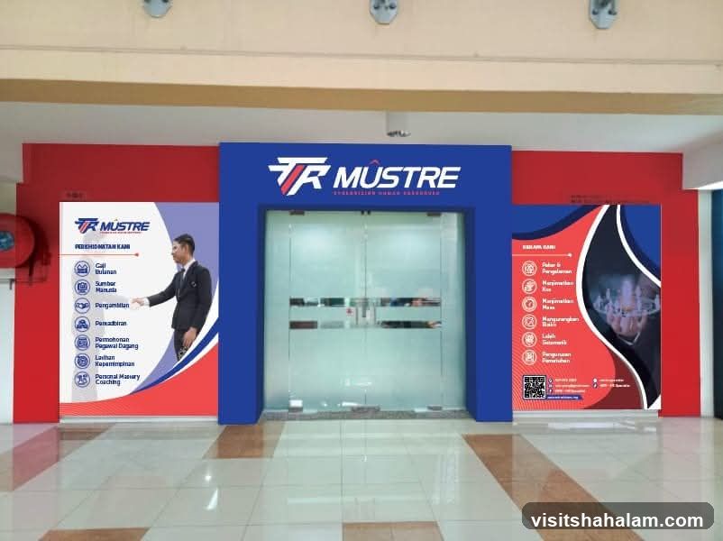 The image shows the entrance to a business called TR Mustre. The entrance features double glass doors framed by a blue structure with the TR Mustre logo prominently displayed above. To the left of the entrance is a large poster with the TR Mustre logo and a list of services including