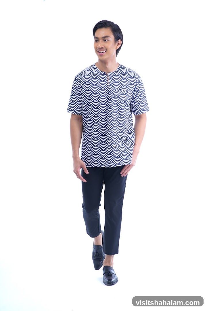 Man in patterned shirt and black pants