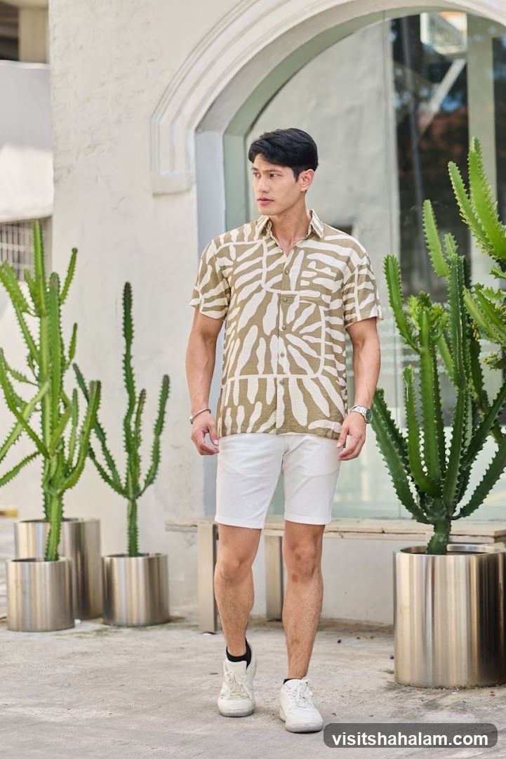 Man in patterned shirt and white shorts