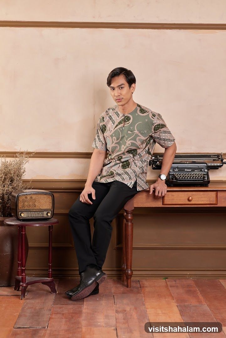 Man in Batik Shirt Posed by Desk