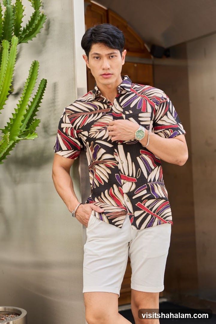 Man in patterned shirt and white shorts