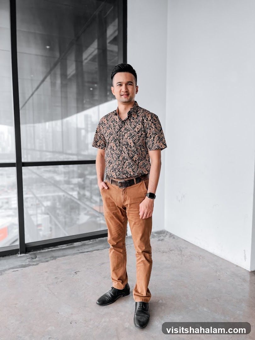 Man in patterned shirt and brown pants