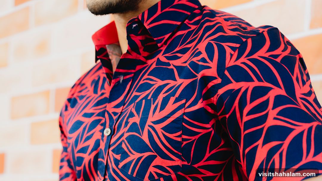 Man Wearing a Red and Blue Leaf-Patterned Shirt
