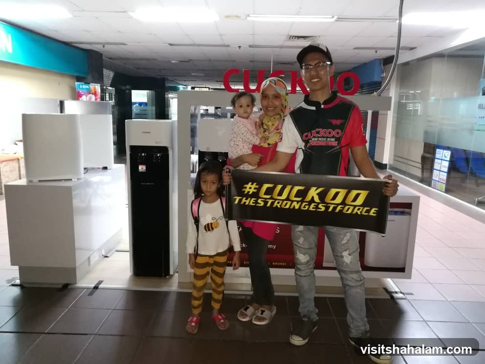 Family Posing with Cuckoo Banner