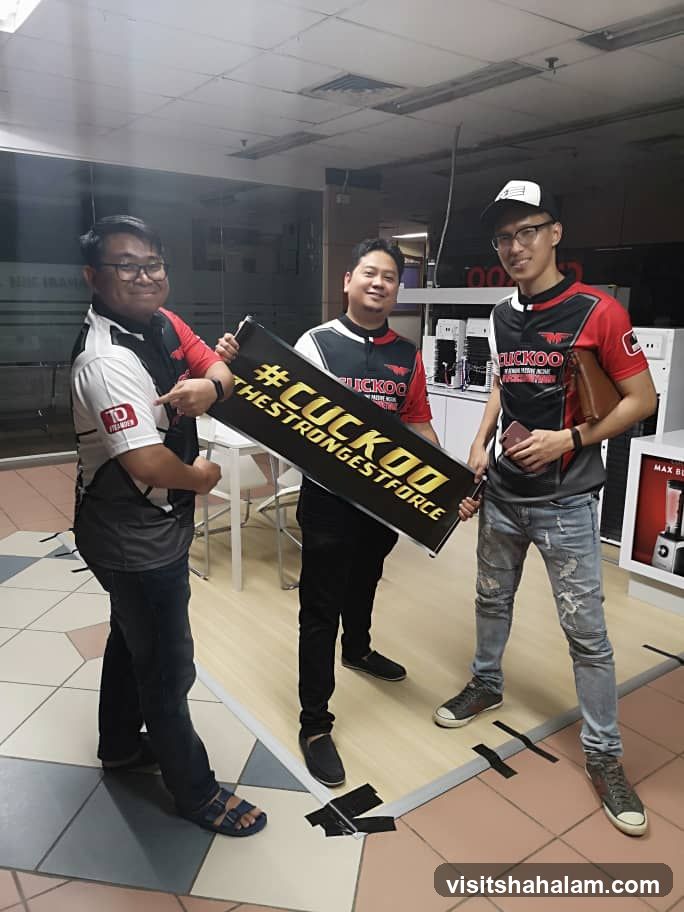 Three men holding a banner
