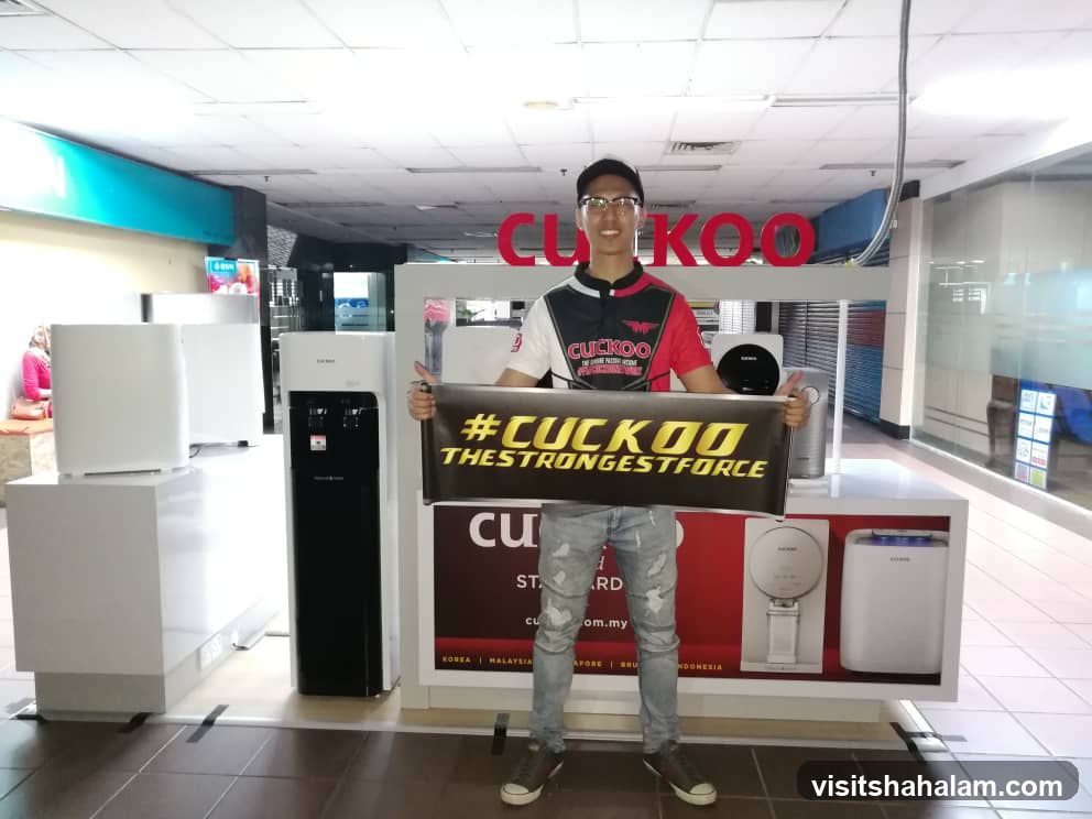 Man holding Cuckoo banner