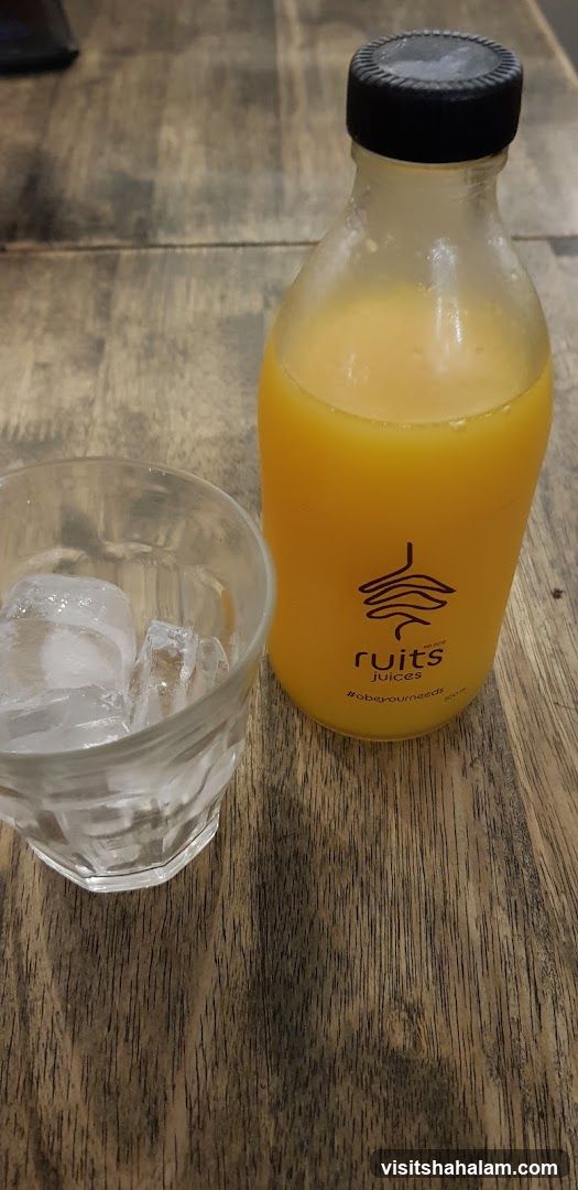 Orange Juice Bottle and Glass of Ice