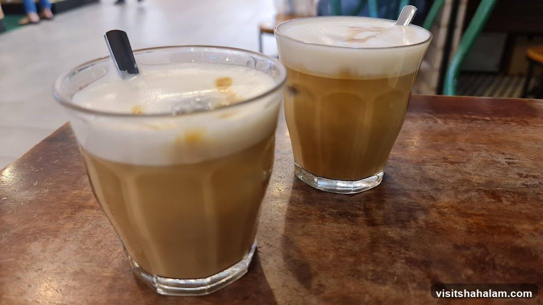 Two iced coffees on a wooden table
