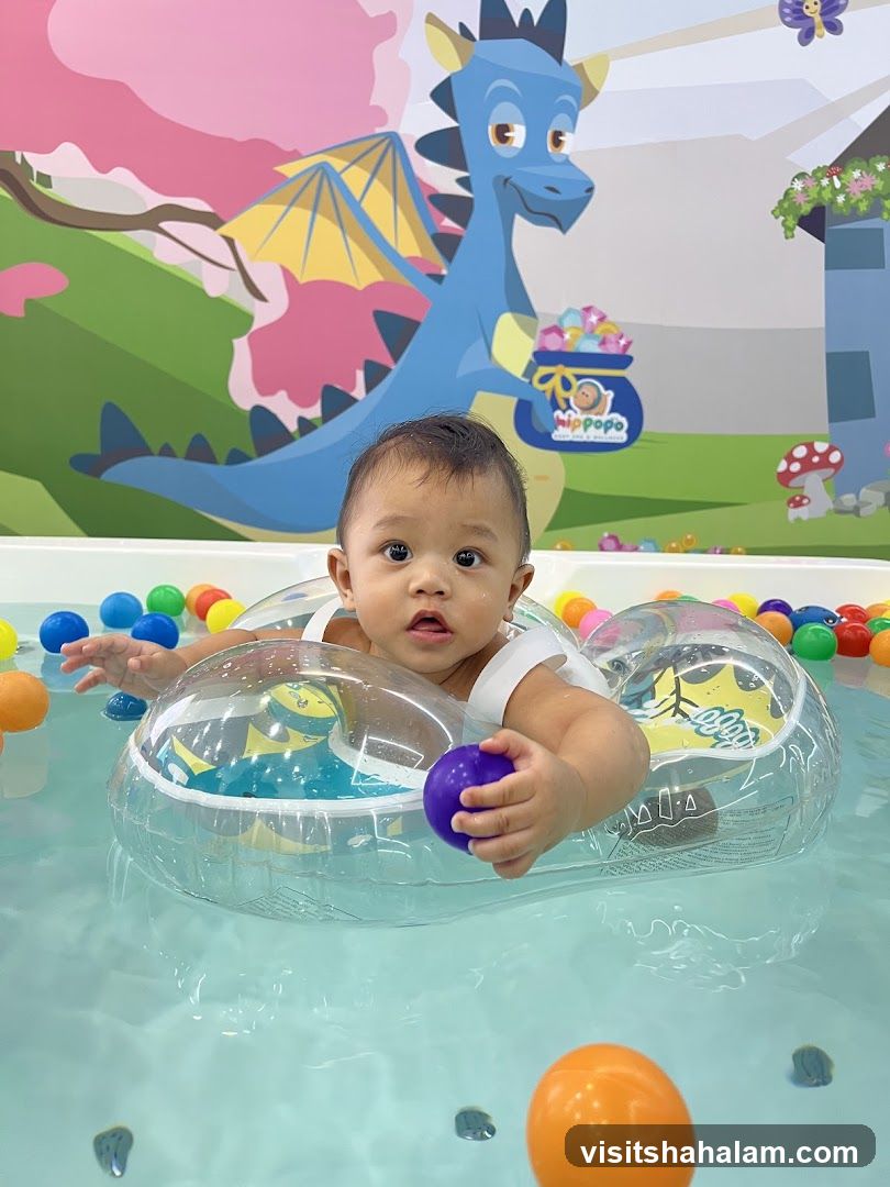 Baby in a pool with colorful balls