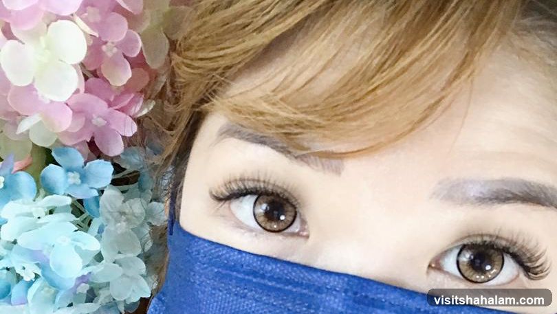 Close-up of eyes with false eyelashes and a blue mask