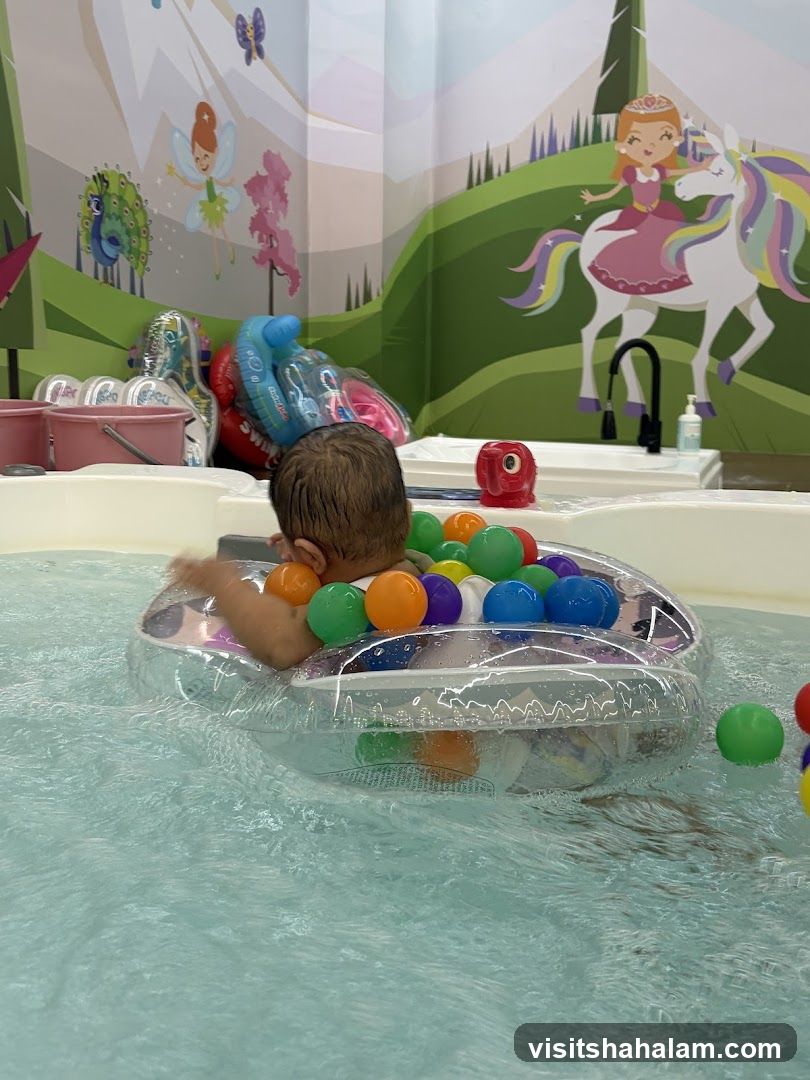 Baby in a pool with colorful balls