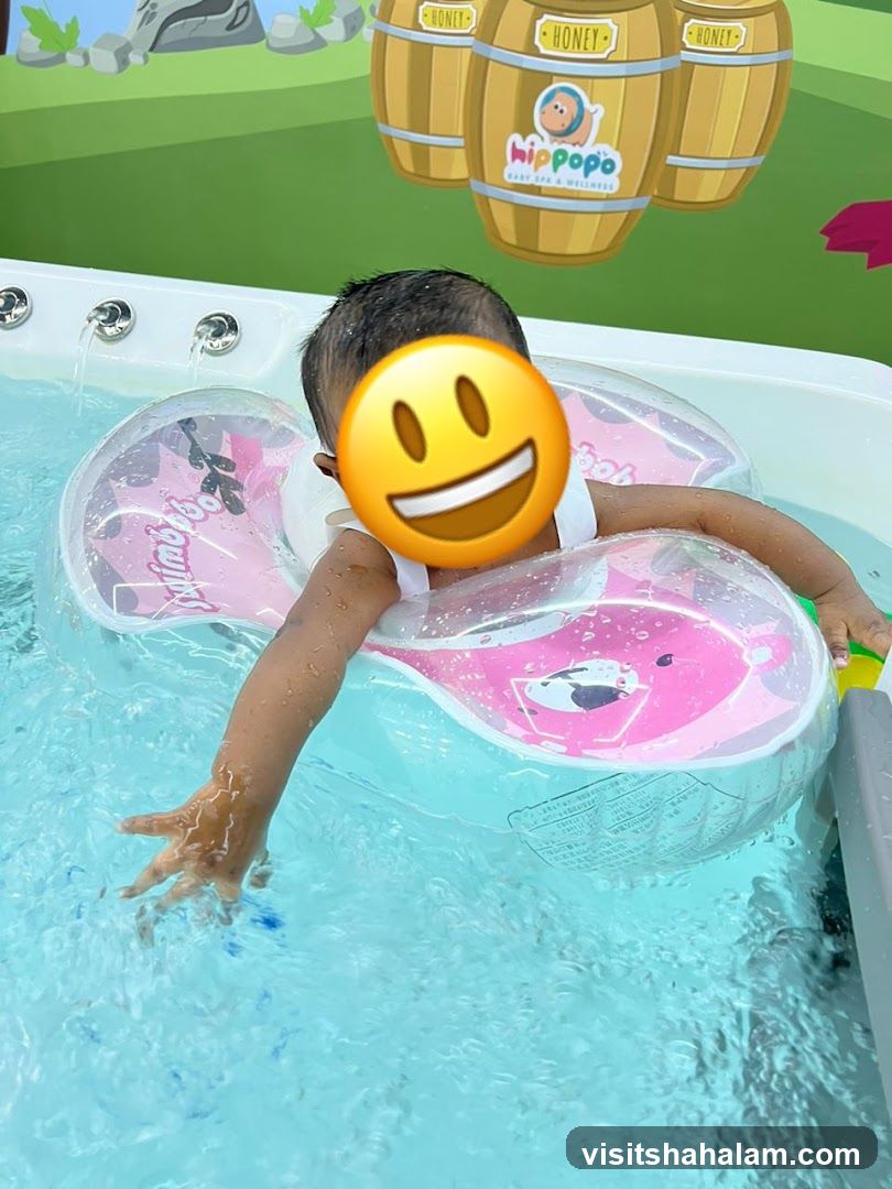 Baby in a pool with a float