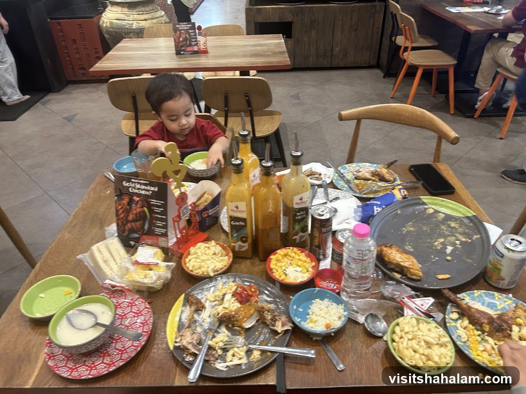 Messy Table with Food and a Child