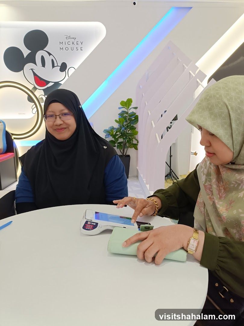 Two women at a table with a payment terminal