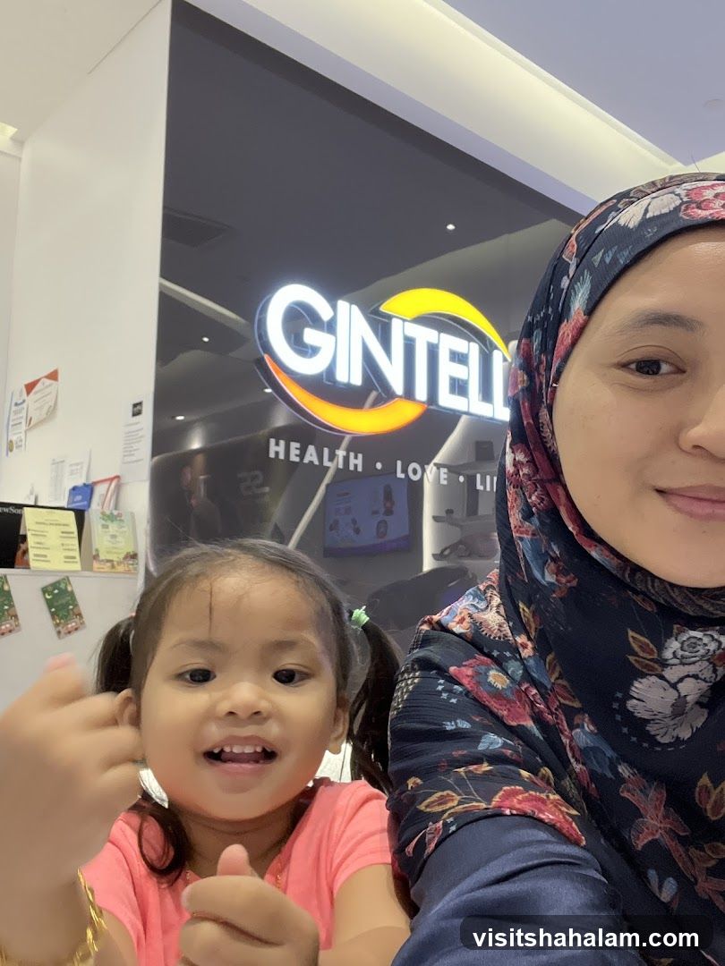 Woman and child in front of Gintell logo