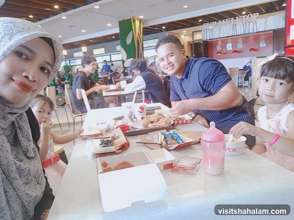 Family enjoying a meal at a food court