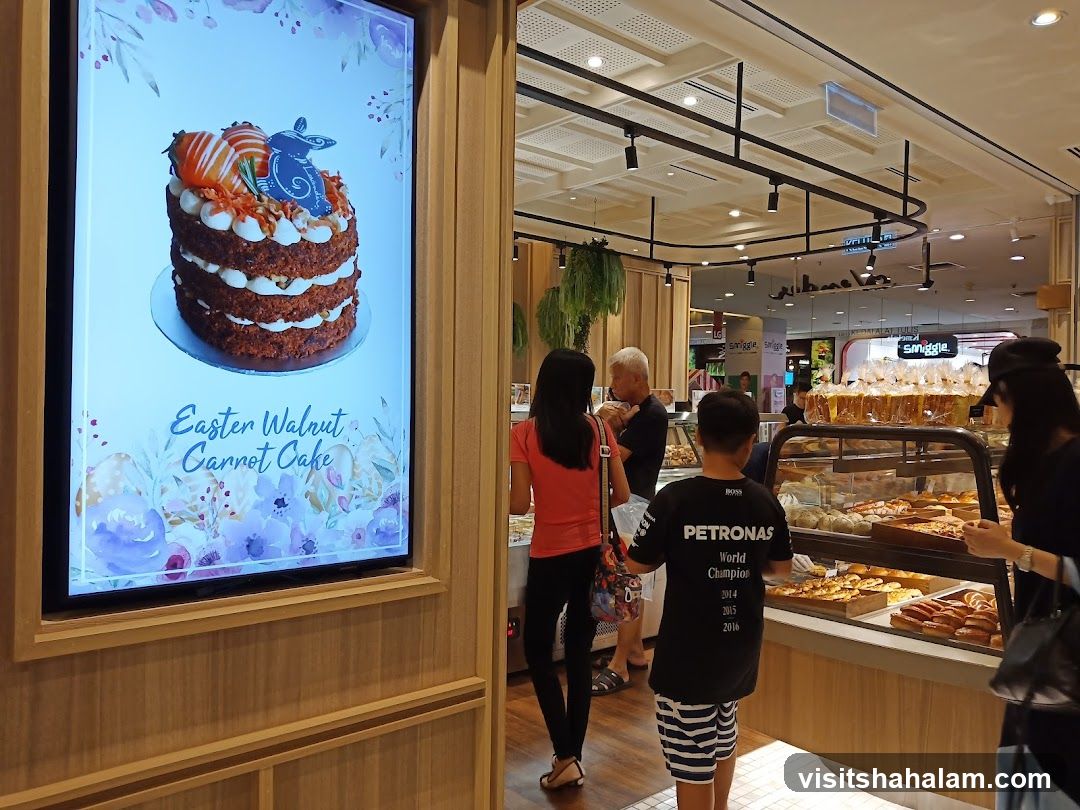 Bakery Display with Easter Cake Advertisement