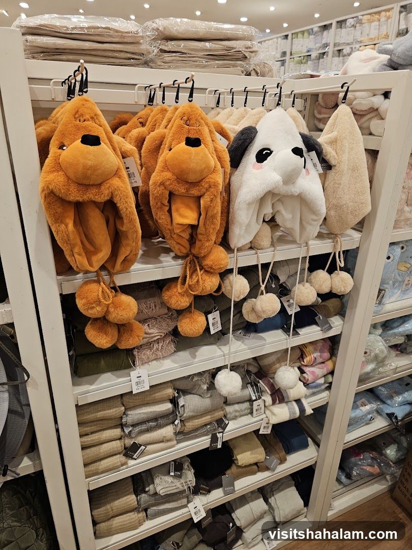 Animal-themed hats and folded textiles on display shelves