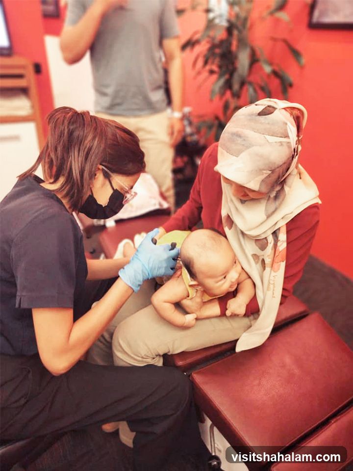Chiropractor adjusting a baby