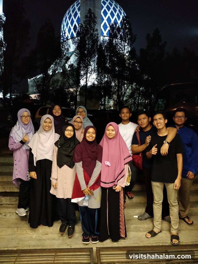 Group of people in front of a mosque