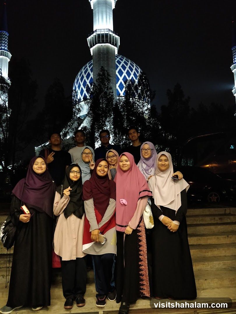 Group of people in front of a mosque at night