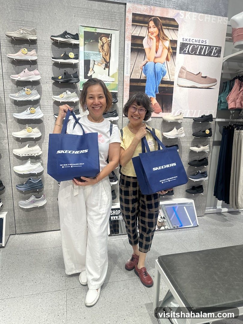 Two Women Holding Skechers Shopping Bags