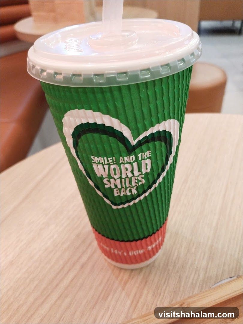 Green cup with a heart logo and text