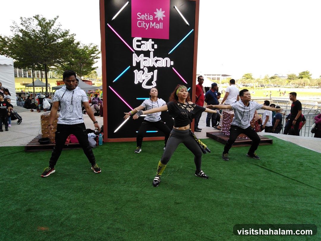People dancing in front of a mall advertisement