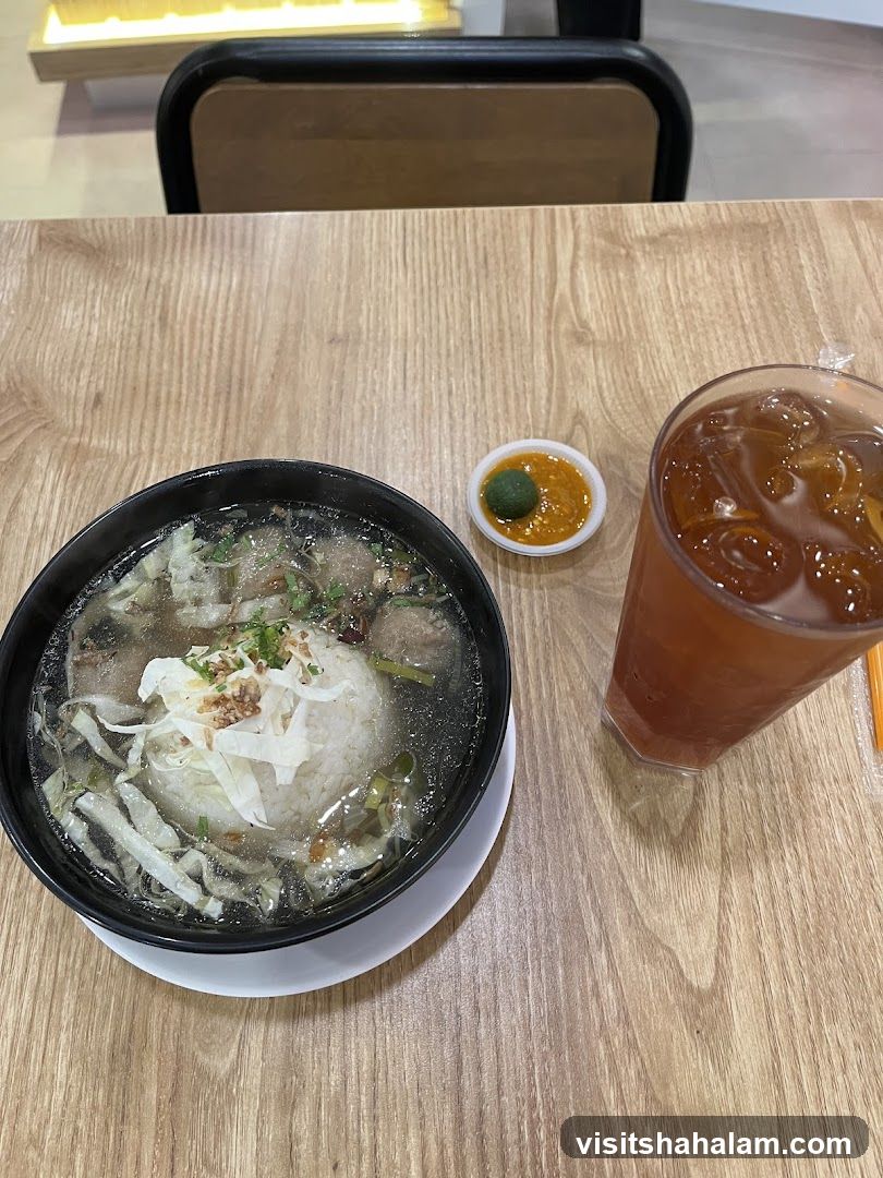 Bowl of Rice Soup with Meatballs and Iced Tea