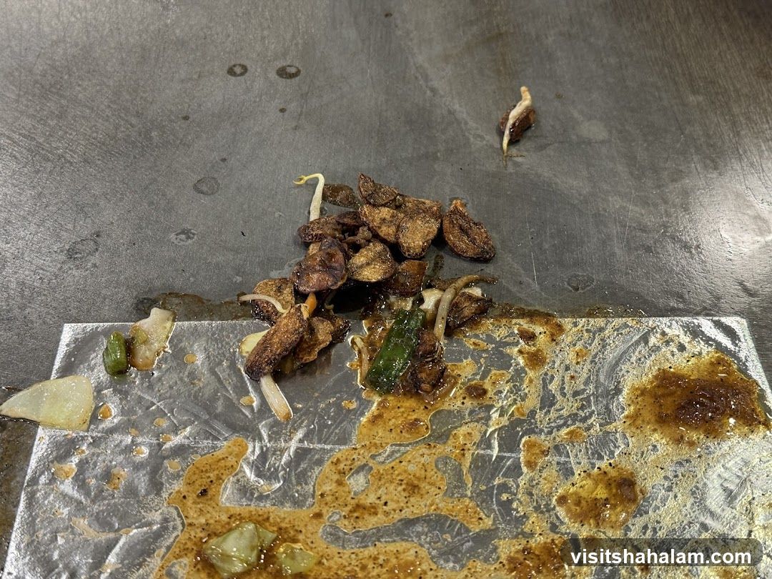 Cooked Food Scraps on Griddle