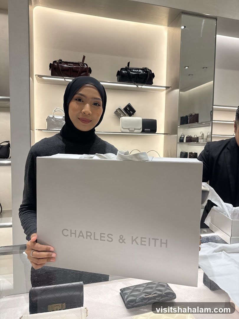 Woman holding a Charles & Keith shopping bag