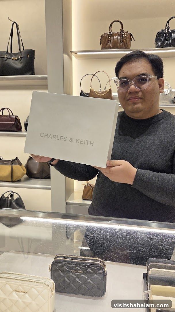 Man holding a Charles & Keith shopping bag