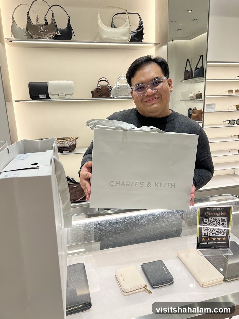 Man holding a Charles & Keith shopping bag