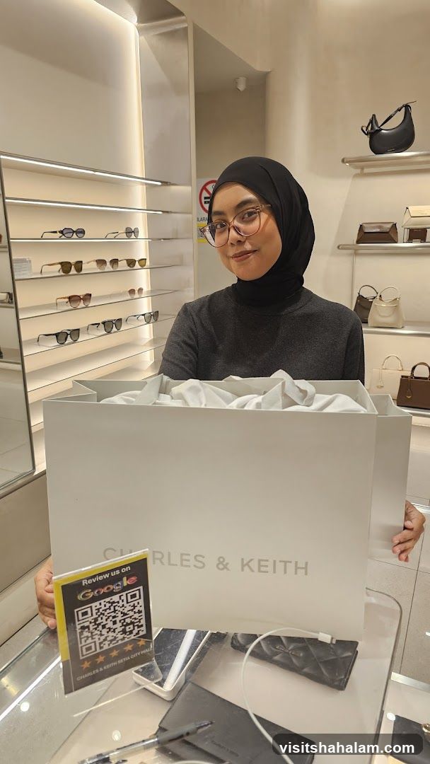 Woman holding a Charles & Keith shopping bag