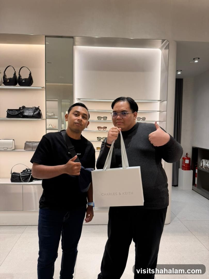 Two Men Posing with a Charles & Keith Shopping Bag