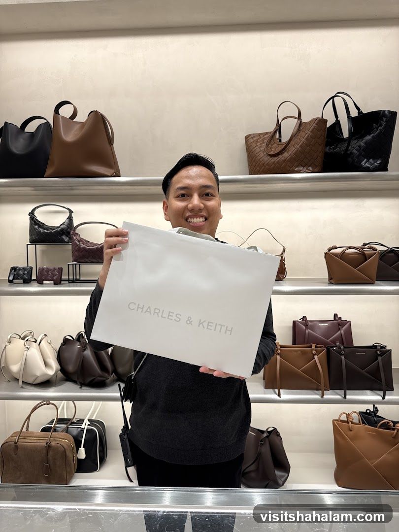 Man holding a Charles & Keith shopping bag