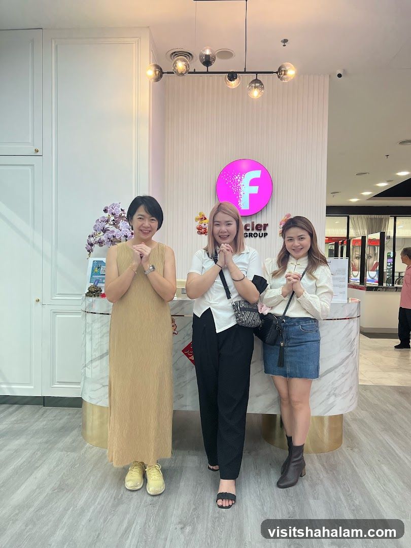 Three women posing at a reception desk