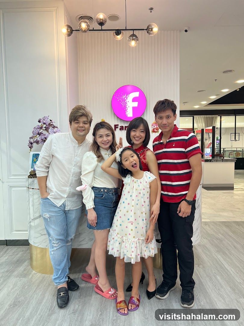 Group Posing in Front of a Business Logo