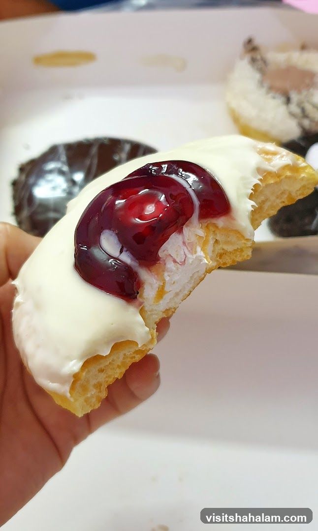 Donut with White Icing and Cherry Topping