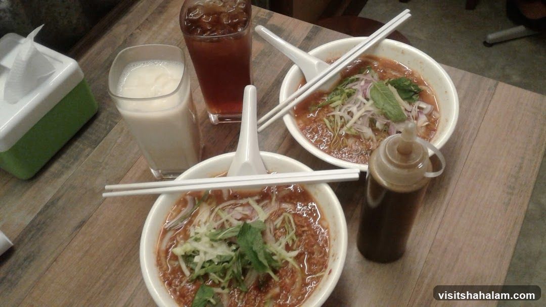 Two bowls of noodles with drinks