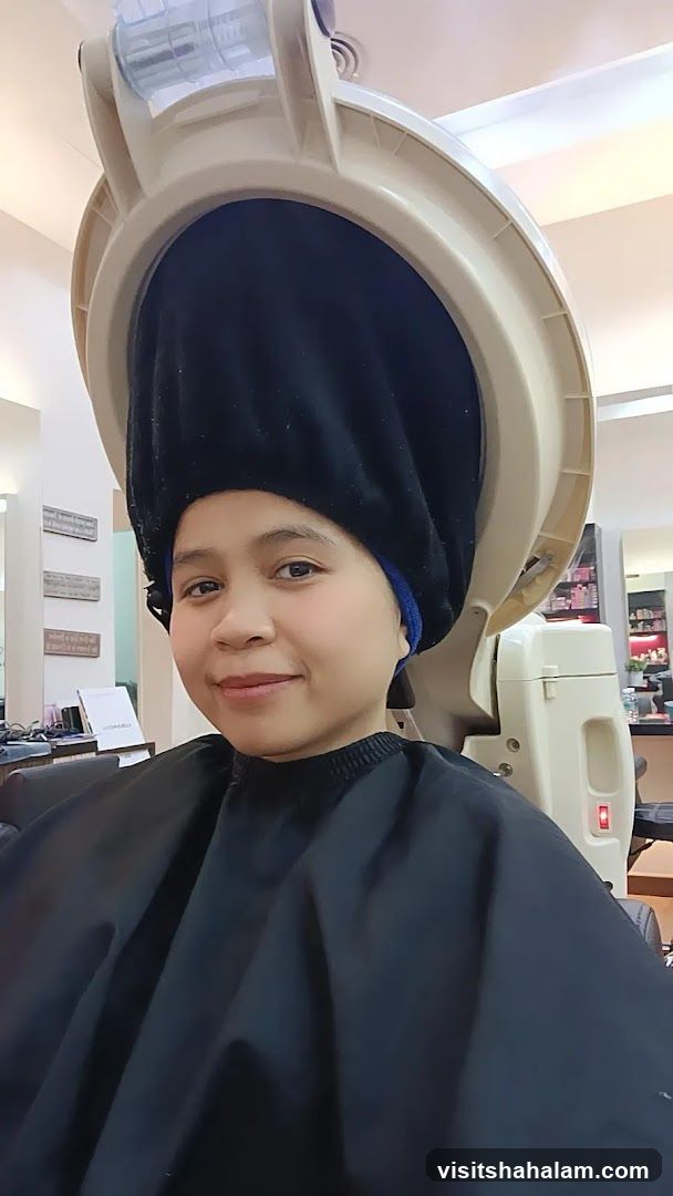 Woman under hair steamer