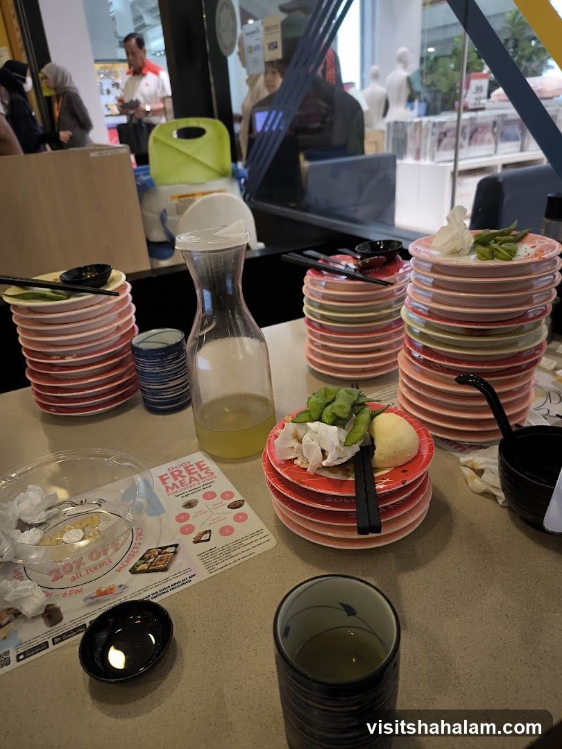 Table with Sushi Plates and Drinks