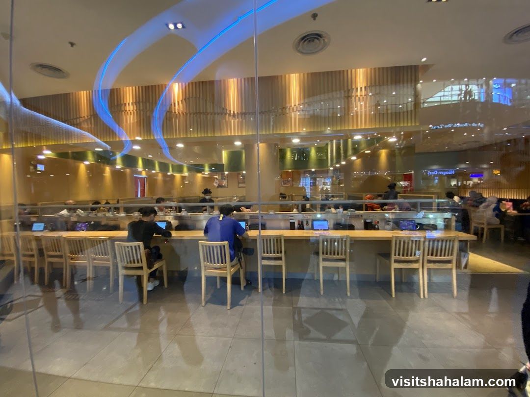 Interior of a restaurant with patrons seated at a counter