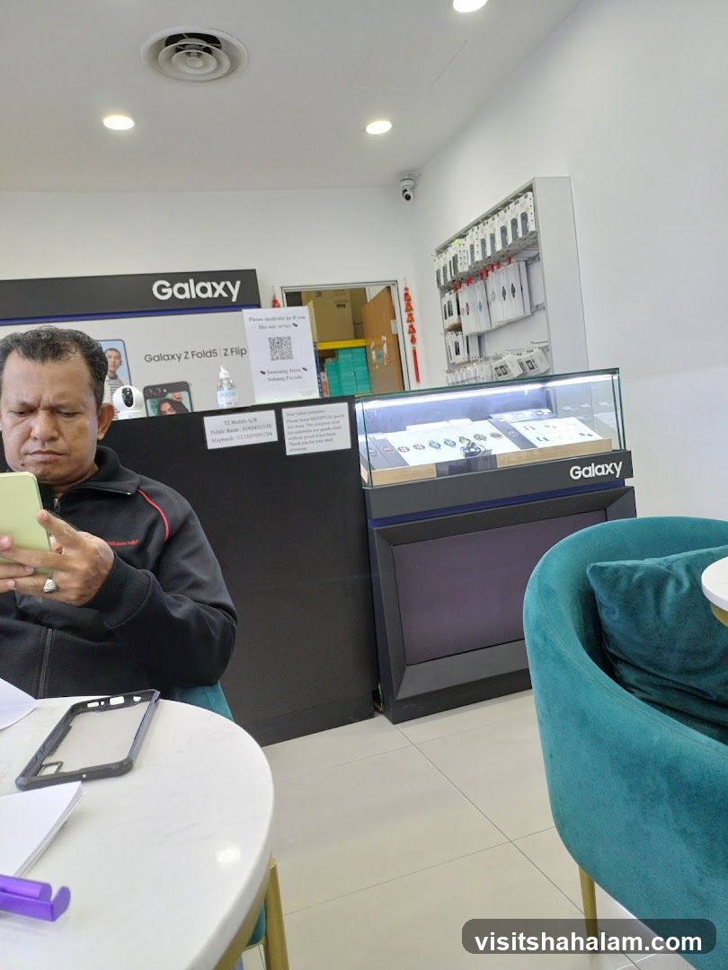 Man looking at phone in a Galaxy store
