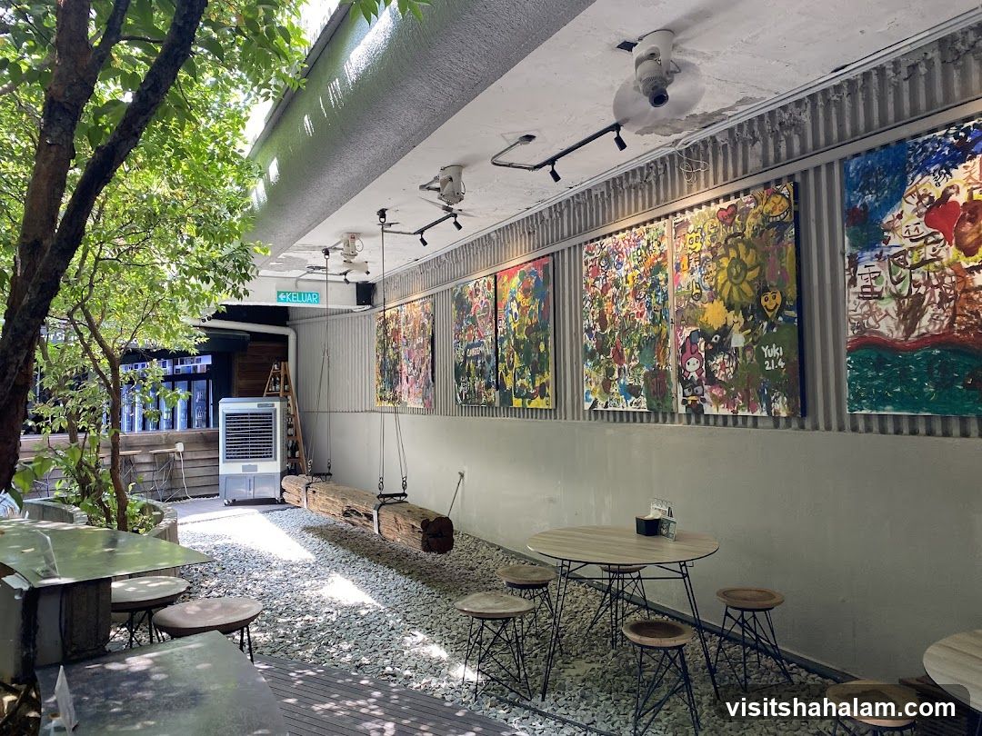 Outdoor seating area with art and greenery