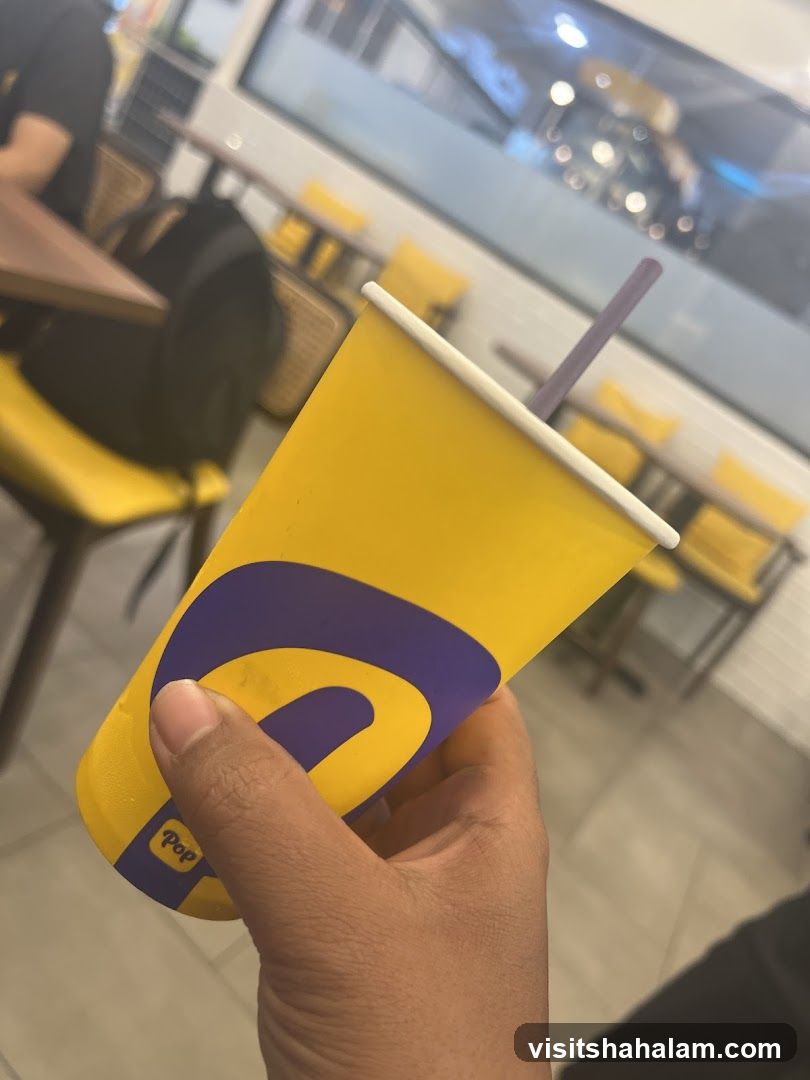 Yellow cup with purple logo